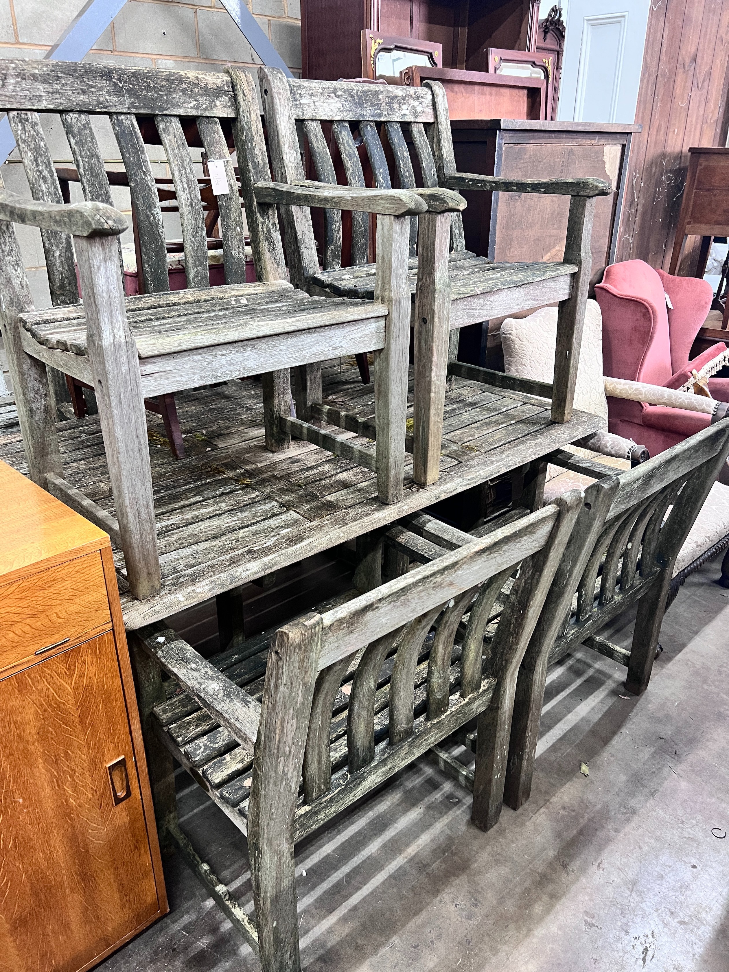 An Alexander Rose weathered teak rectangular garden table with a set of five matching armchairs, table length 161cm *Please note the sale commences at 9am.